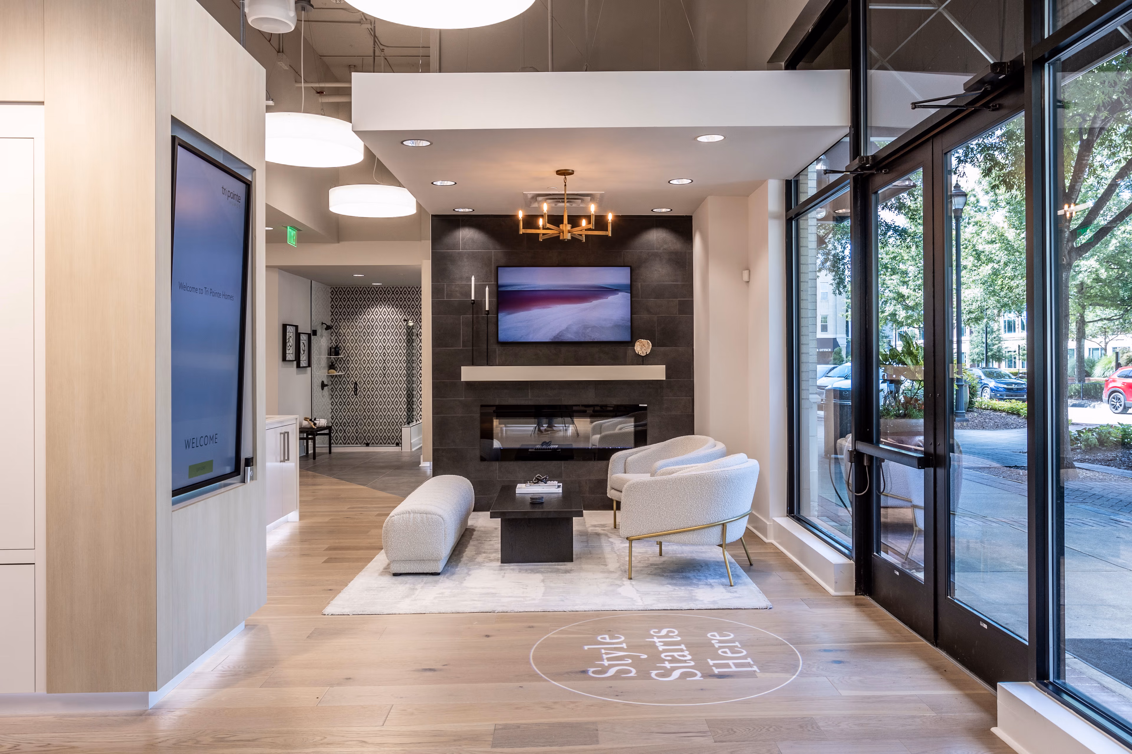 A modern and stylish interior design with a fireplace, comfortable seating, and large windows overlooking the outdoors.