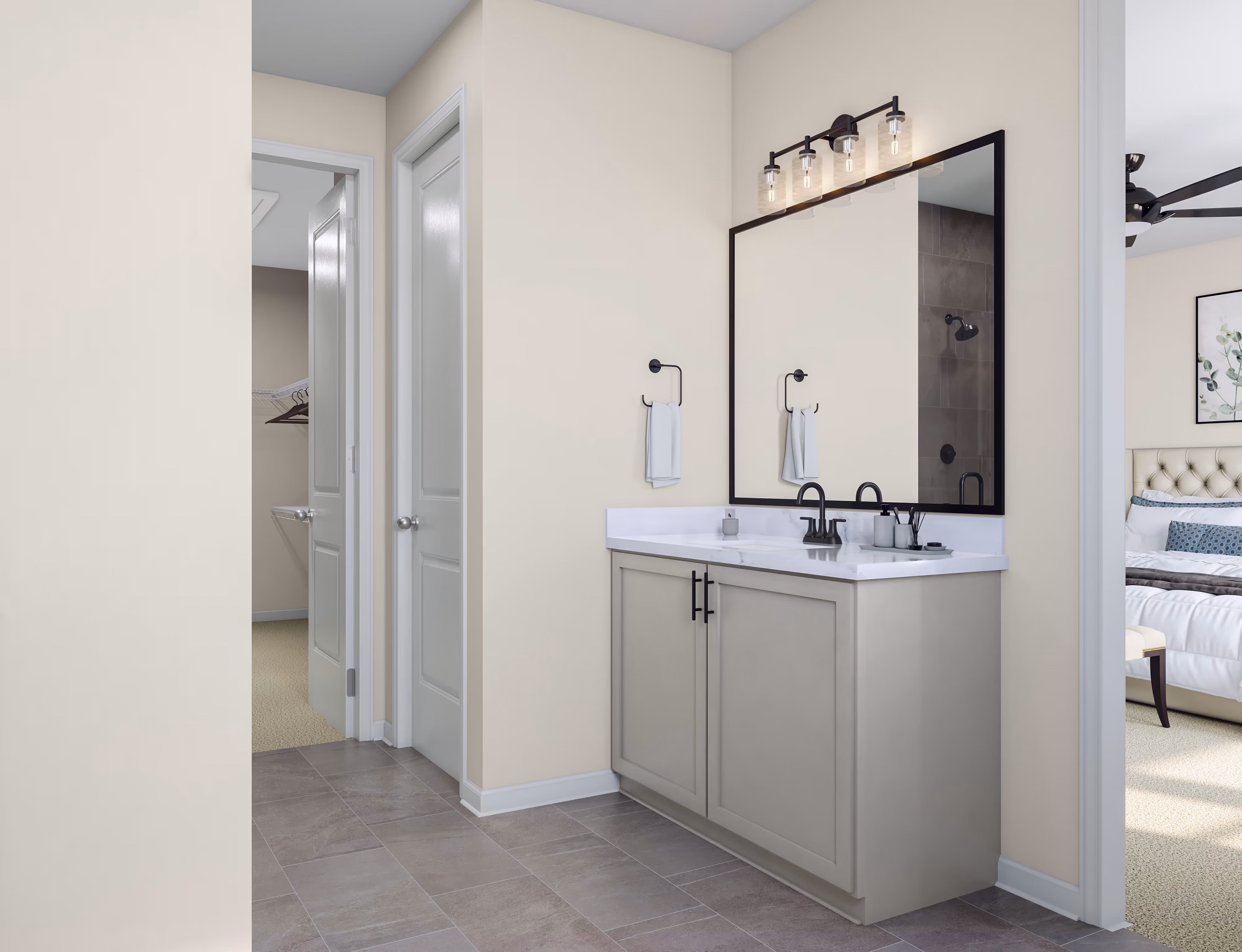 A modern and minimalist bathroom with a gray vanity, a large mirror, and a track lighting fixture above it, set against a neutral-colored wall and floor.